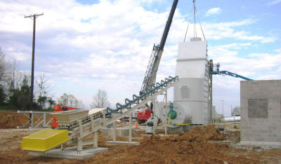 Inclined trough belt conveyor feeding into a Stark Fluid Bed Dryer at a frac sand plant.