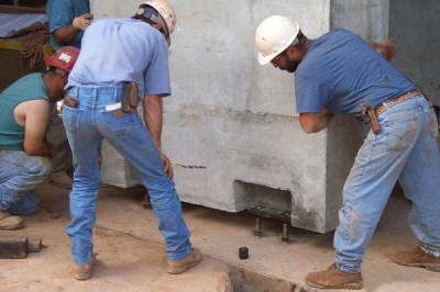 Installation and leveling of a precast concrete steel structure.
