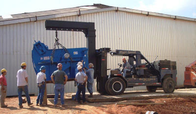 Rigging and handling of a 56,000 lb crusher for installation in an area not accessible by a crane.