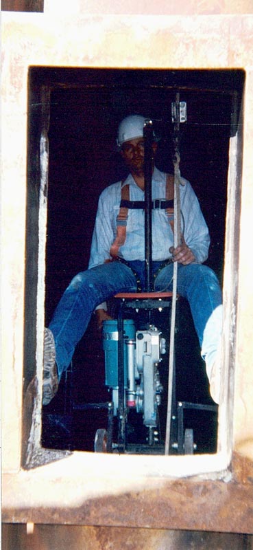 Electric powered Bolson Chair utilized to access the inside liner of two 120' tall exhaust stacks in order to perform repairs during a refurbishment project.