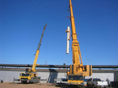 Setting the base section of a 101' freestanding exhaust stack at a 131' radius using a 500 ton hydraulic truck crane as well as a 125 ton truck crane for tailing and man basket access.